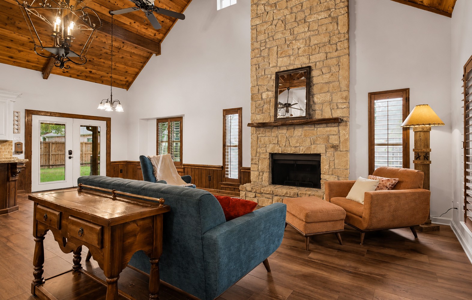 312 Springwood Drive Conroe, TX 77385 - Photo 10 of 50 Spacious living room featuring soaring ceilings, exposed wood beams, and a cozy wood-burning fireplace.