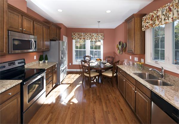 a kitchen with granite countertop lots of counter top space a sink appliances and cabinets