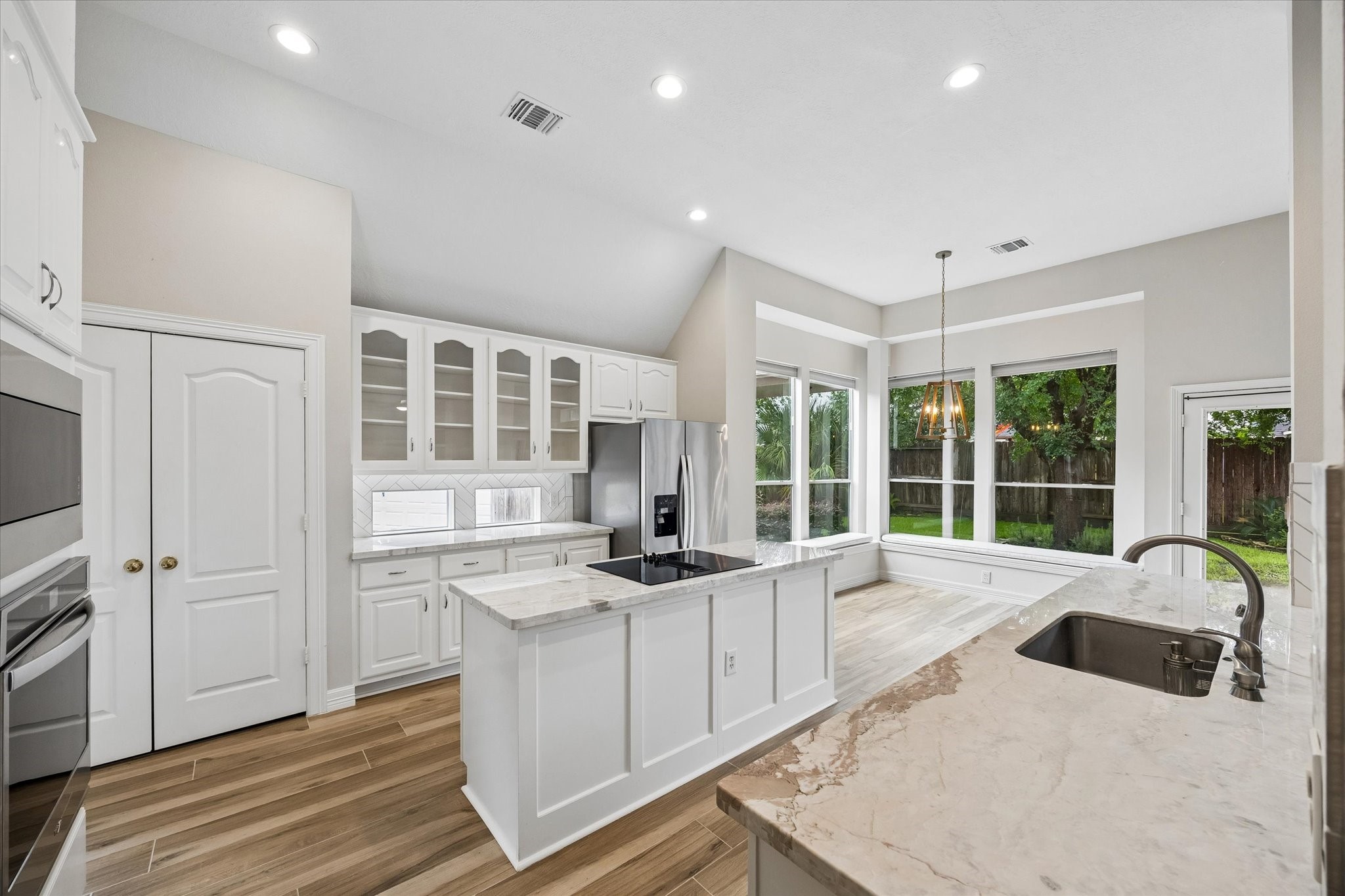 5306 Summerland Ridge Court Houston, TX 77041 - Photo 11 of 33 a large white kitchen with granite countertop a sink and cabinets