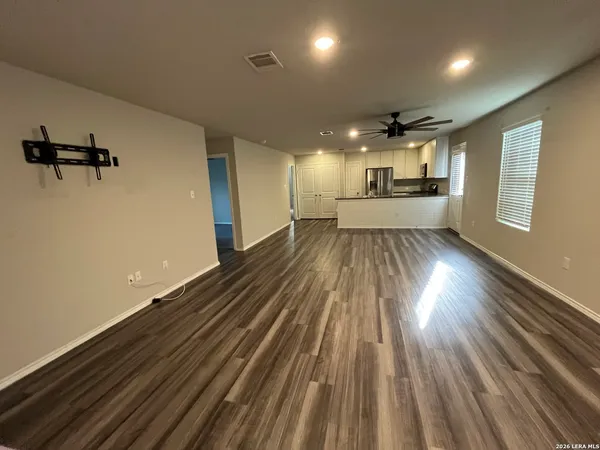 a view of a room with wooden floor
