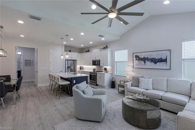 a living room with furniture and kitchen view