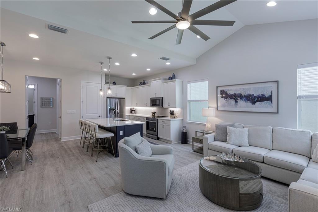 a living room with furniture and kitchen view