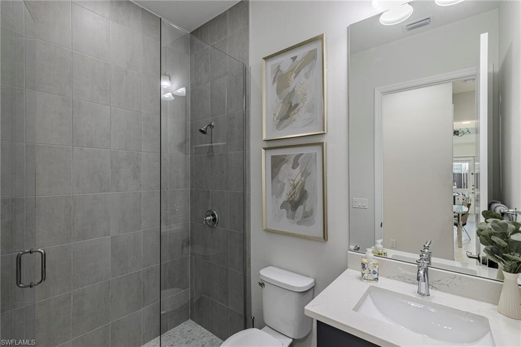 7138 Cayo Coco Lane Naples, FL 34113 - Photo 14 of 42 a bathroom with a sink toilet and shower