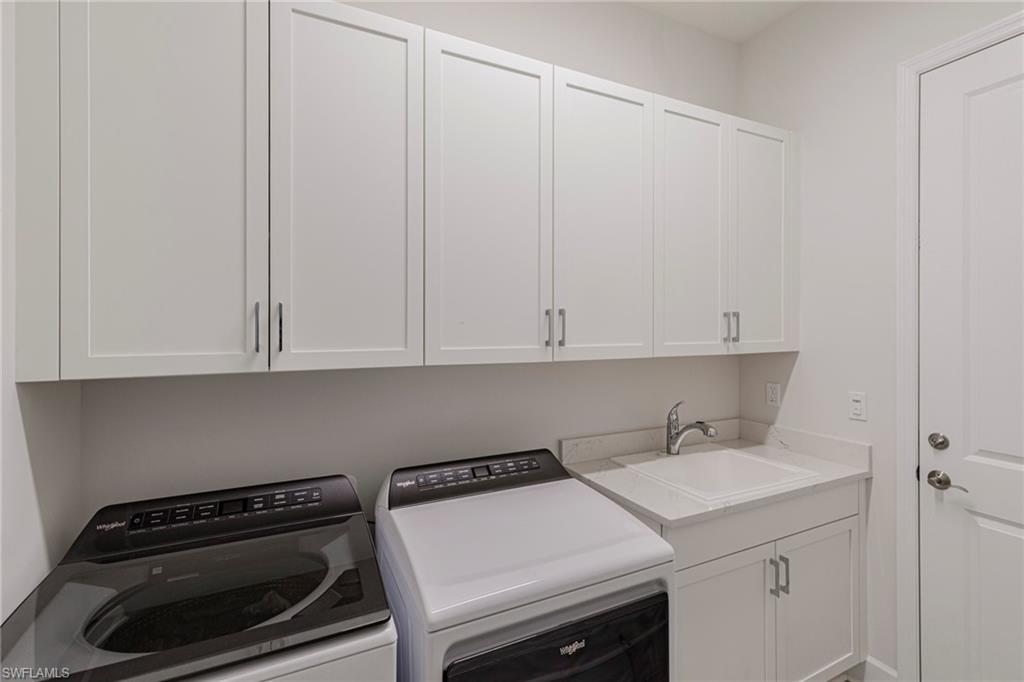 7138 Cayo Coco Lane Naples, FL 34113 - Photo 15 of 42 a utility room with a sink a cabinetry and a window