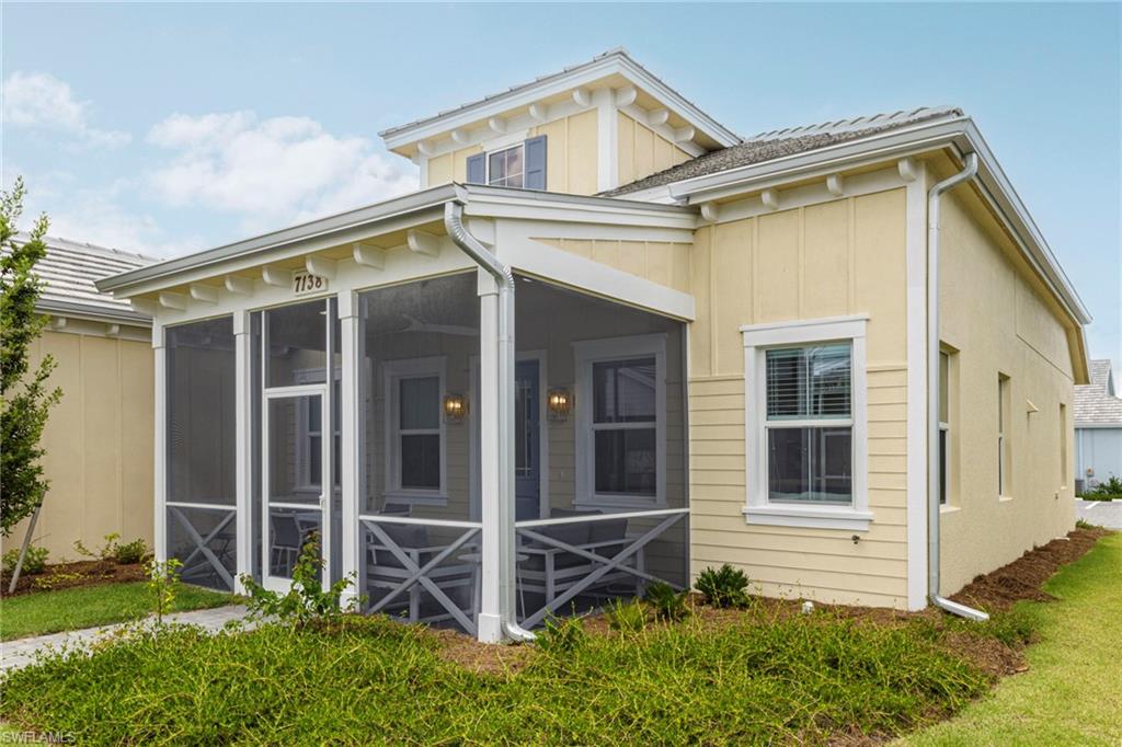 7138 Cayo Coco Lane Naples, FL 34113 - Photo 2 of 42 a view of a house with a small yard and wooden floor and fence