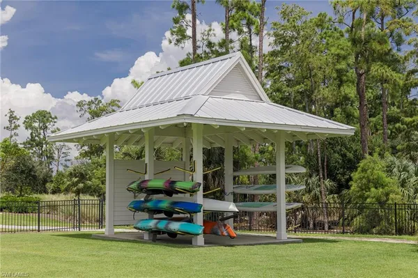 a view of a swimming pool with lawn chairs and a yard