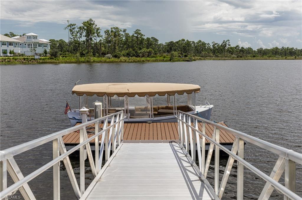 7138 Cayo Coco Lane Naples, FL 34113 - Photo 30 of 42 a view of a lake and trees in the background