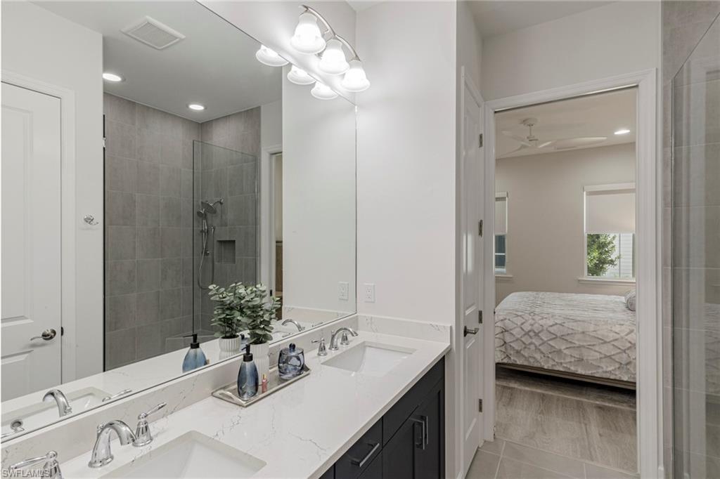 7138 Cayo Coco Lane Naples, FL 34113 - Photo 10 of 42 a bathroom with a sink a vanity and a mirror