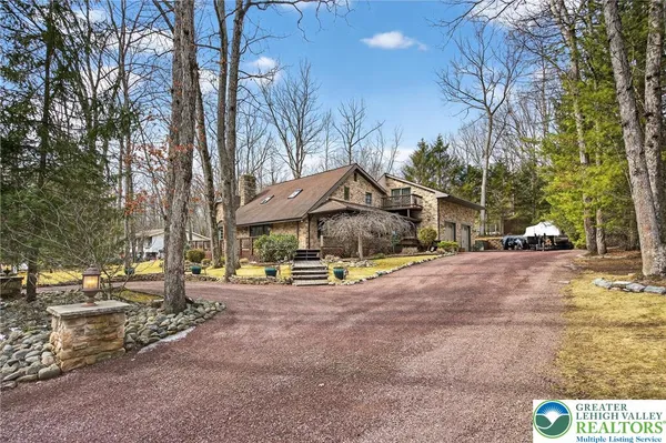 a kitchen with stainless steel appliances granite countertop a stove top oven a dining table and chairs with wooden floor