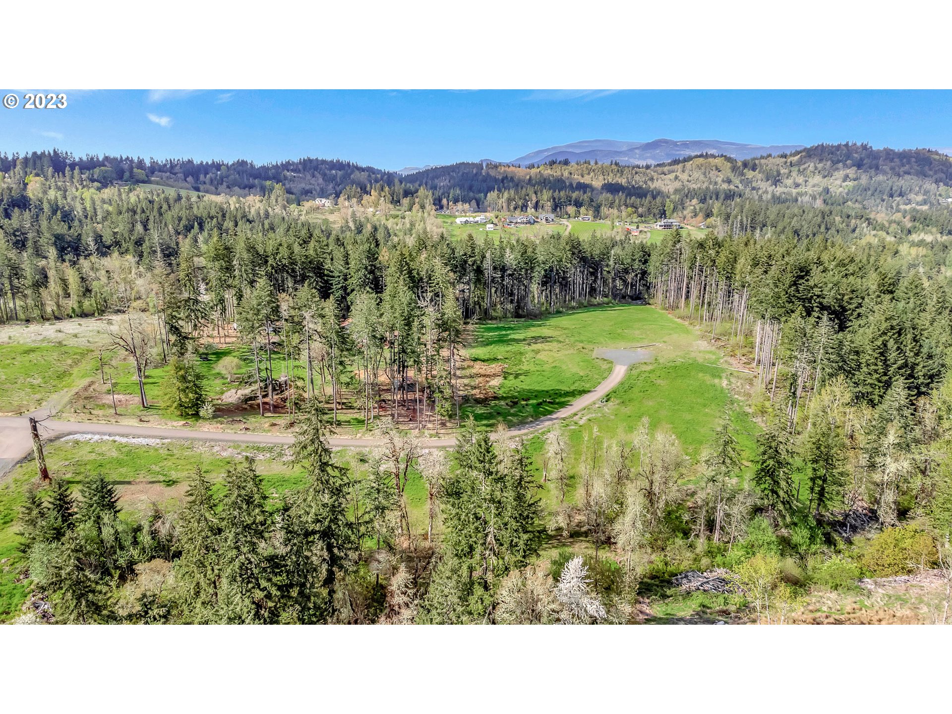 Spring Boulevard Eugene, OR 97405 - Photo 23 of 34 a view of a lush green field with mountains in the background