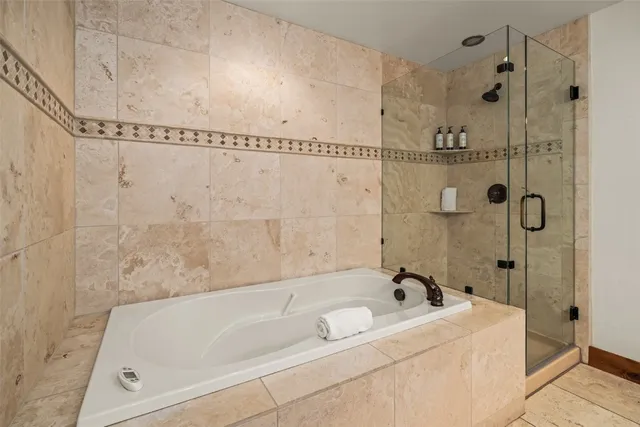 a bathroom with a tub a sink and shower