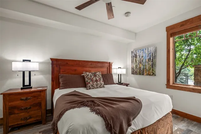 a bedroom with a bed and a lamp on table