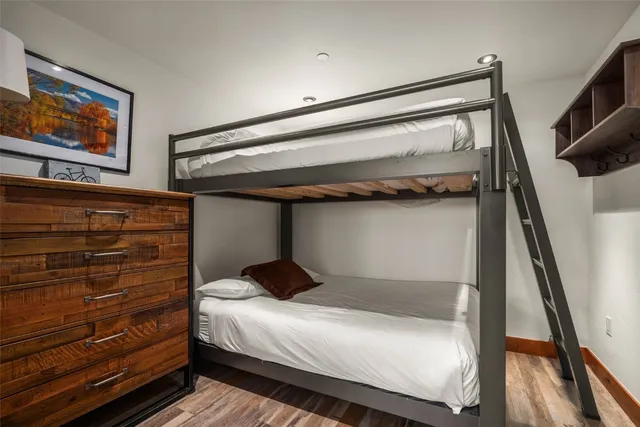 a bedroom with a bed and a painting on the wall