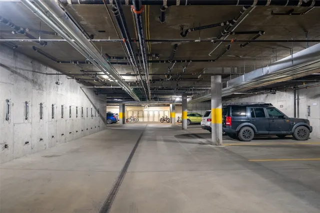 a view of parking garage with cars