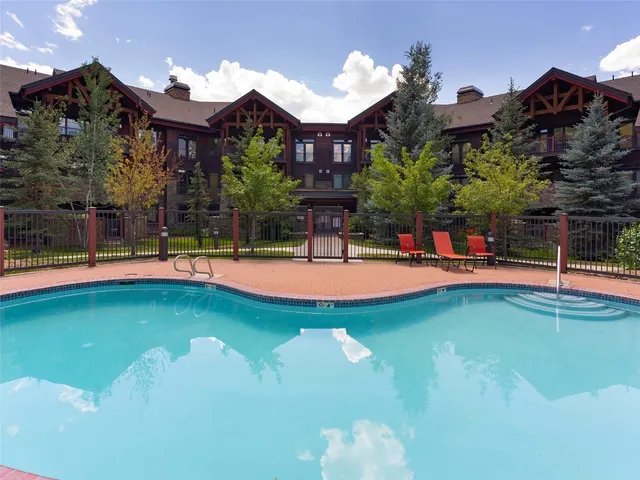 a swimming pool with outdoor seating and yard