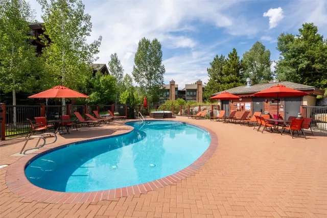 an outdoor space with pool and furniture