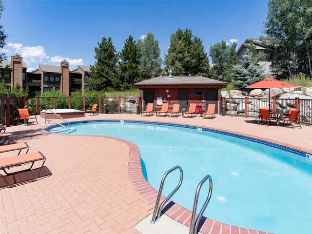 a view of a swimming pool with lounge chairs in patio
