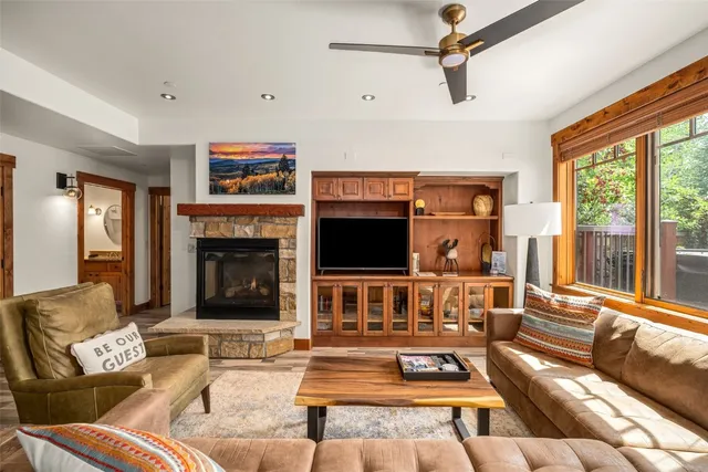 a living room with furniture flat screen tv and a fireplace
