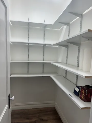 a view of walk in closet with empty racks