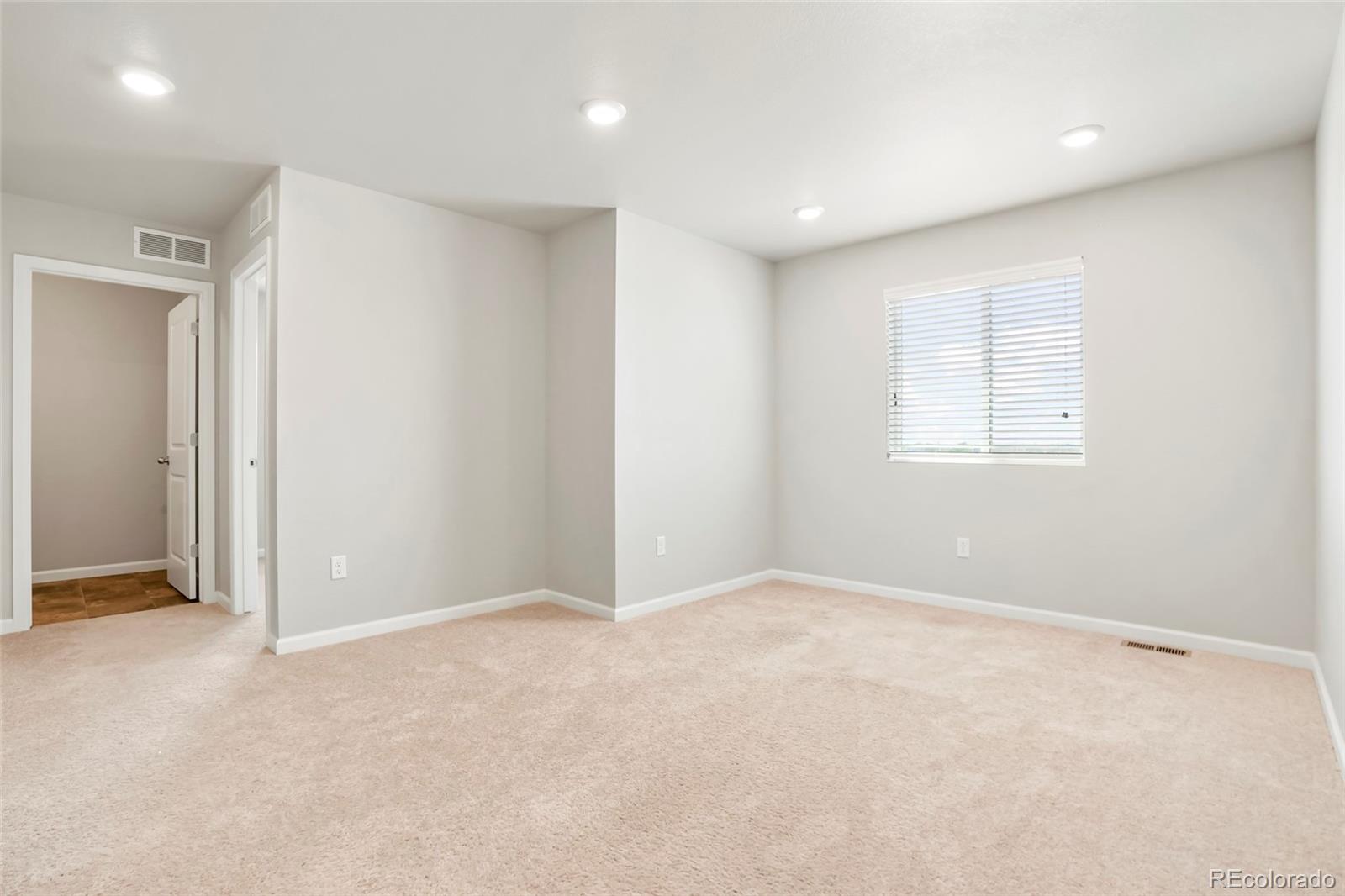 1843 Homestead Drive Fort Lupton, CO 80621 - Photo 20 of 33 an empty room with windows and closet