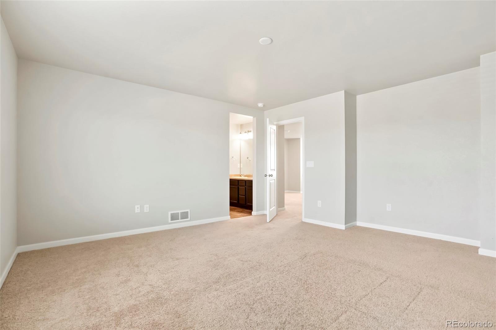 1843 Homestead Drive Fort Lupton, CO 80621 - Photo 24 of 33 a view of an empty room with wooden floor