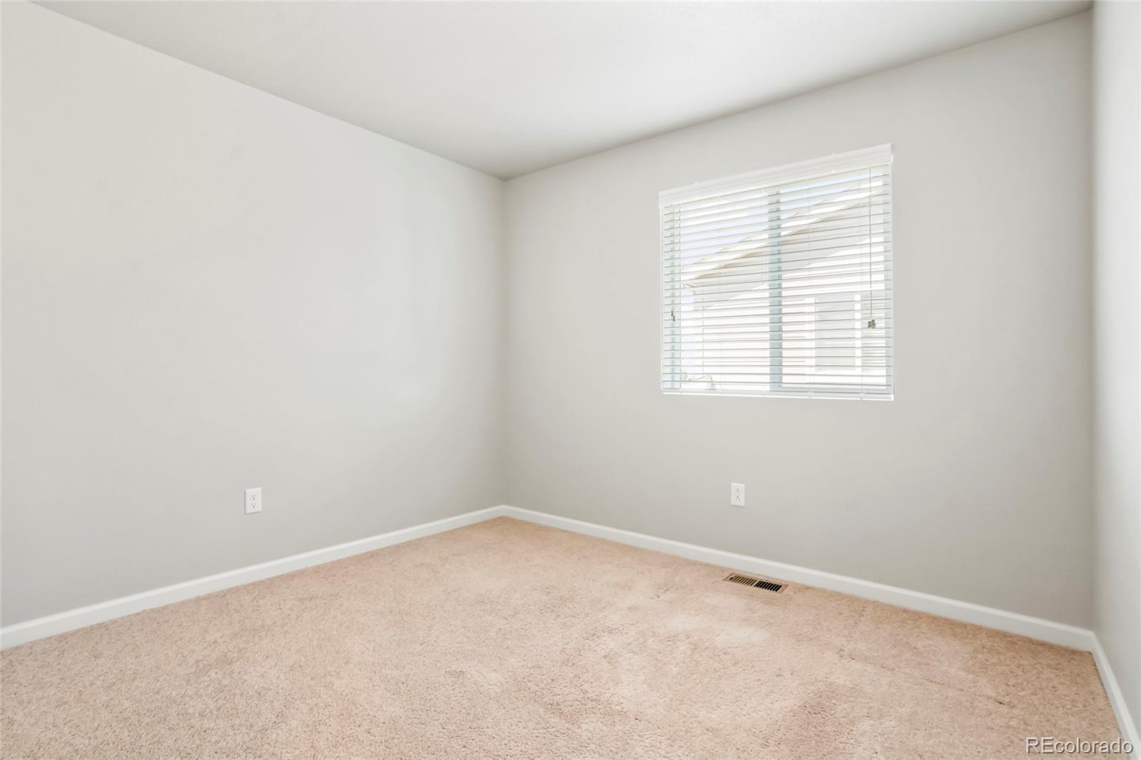 1843 Homestead Drive Fort Lupton, CO 80621 - Photo 25 of 33 an empty room with a window