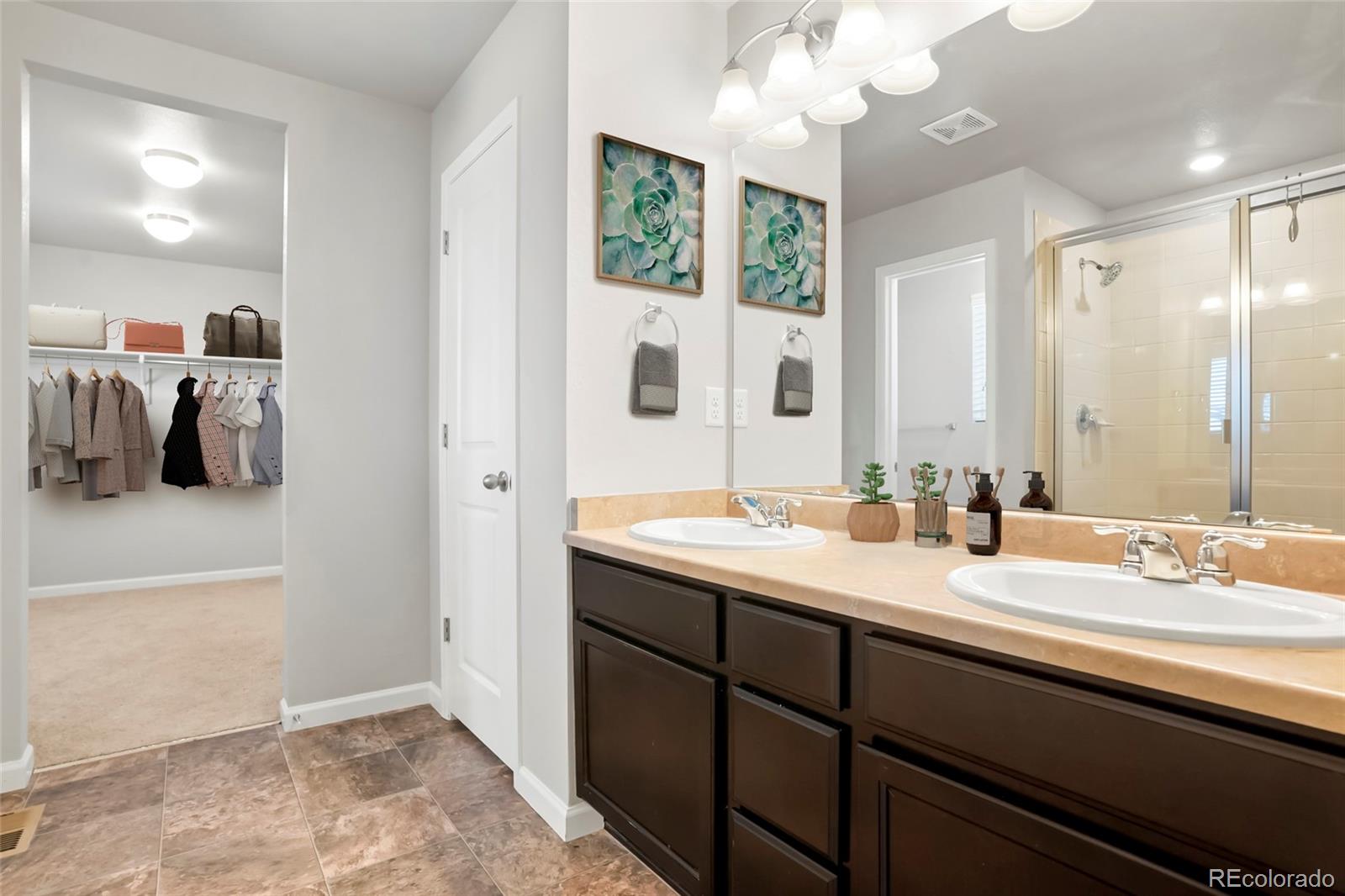 1843 Homestead Drive Fort Lupton, CO 80621 - Photo 5 of 33 a en suite bathroom with a double vanity sink and a mirror