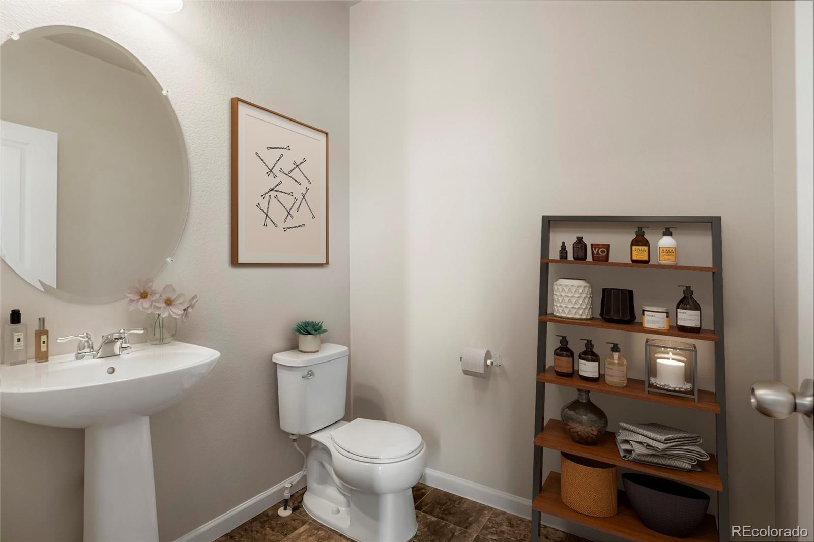 1843 Homestead Drive Fort Lupton, CO 80621 - Photo 10 of 33 a bathroom with a toilet sink and mirror