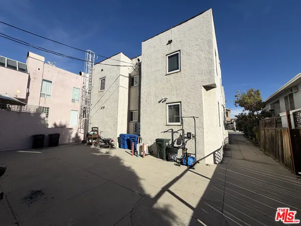 a aerial view of multi story residential apartment building with yard