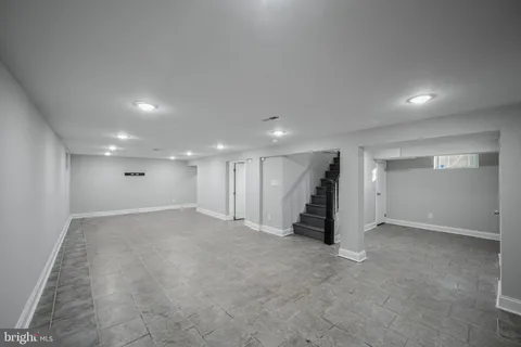 an empty room with walk in closet and wooden floor