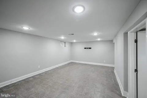 an empty room with a empty space and windows