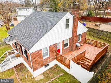 a view of a roof deck with wooden floor and fence
