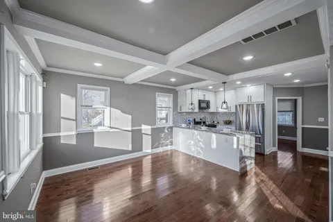 a large kitchen with lots of counter space wooden floor and appliances