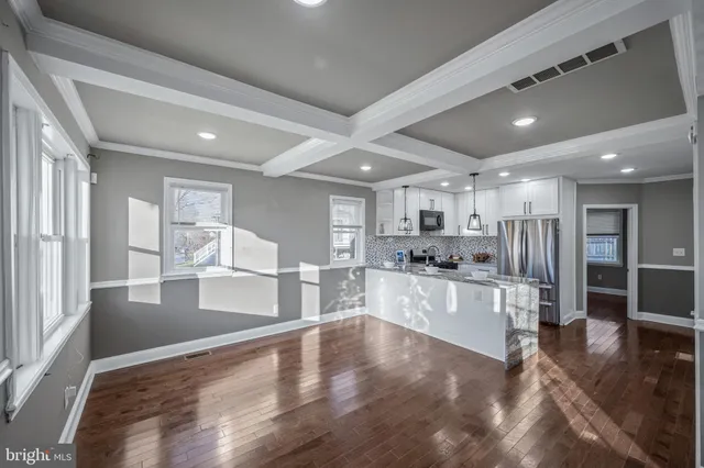 a large kitchen with lots of counter space wooden floor and appliances