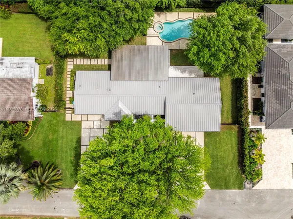an aerial view of a house with a yard and garden