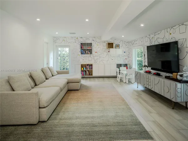 a living room with furniture and a flat screen tv