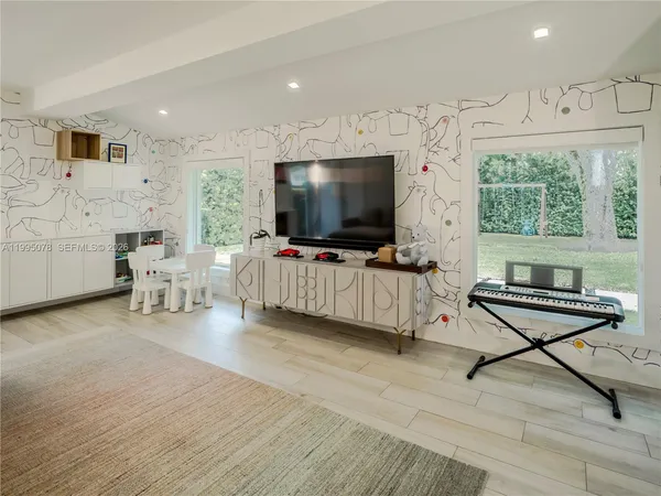 a living room with furniture and a flat screen tv
