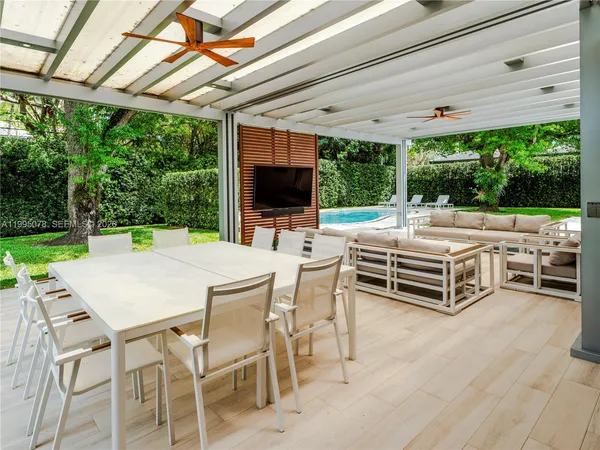 a outdoor space with a large pool table and chairs