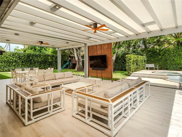 a view of a patio with table and chairs a barbeque with wooden fence