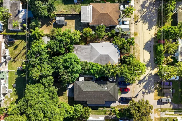 an aerial view of a house with a yard and garden