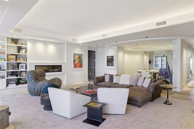 a living room with furniture a large window and a flat screen tv