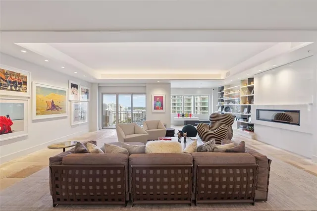 a living room with furniture and a dining table with garden view