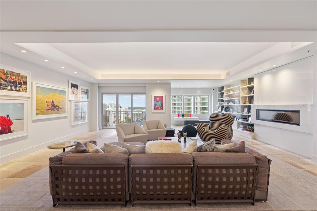 1111 Ritz Carlton Drive, Unit 1704 Sarasota, FL 34236 - Photo 18 of 53 a living room with furniture a large window and a flat screen tv