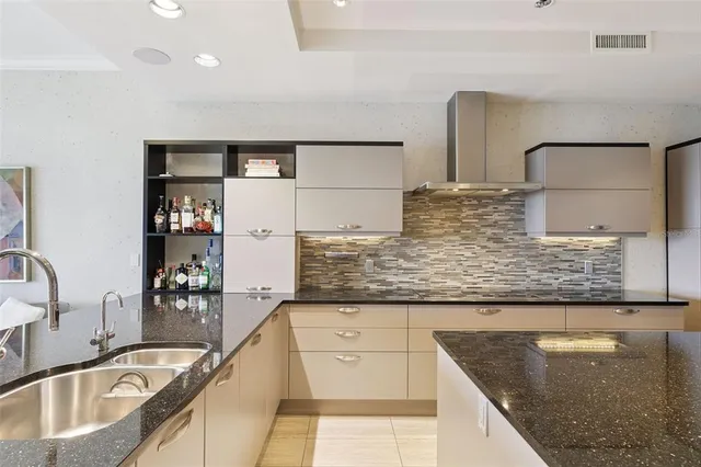 a kitchen with stainless steel appliances granite countertop a sink and cabinets