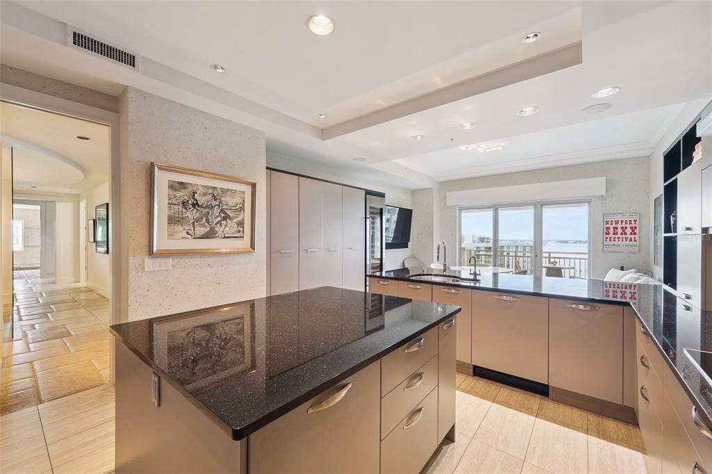 1111 Ritz Carlton Drive, Unit 1704 Sarasota, FL 34236 - Photo 24 of 53 a kitchen with stainless steel appliances granite countertop a sink a stove top oven a counter space and cabinets