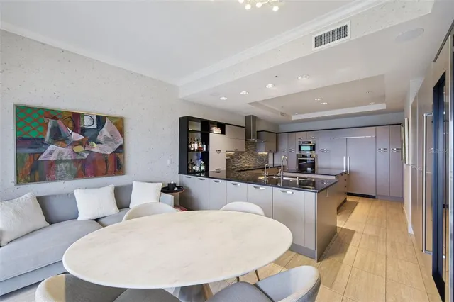 a living room with furniture a flat screen tv and a floor to ceiling window