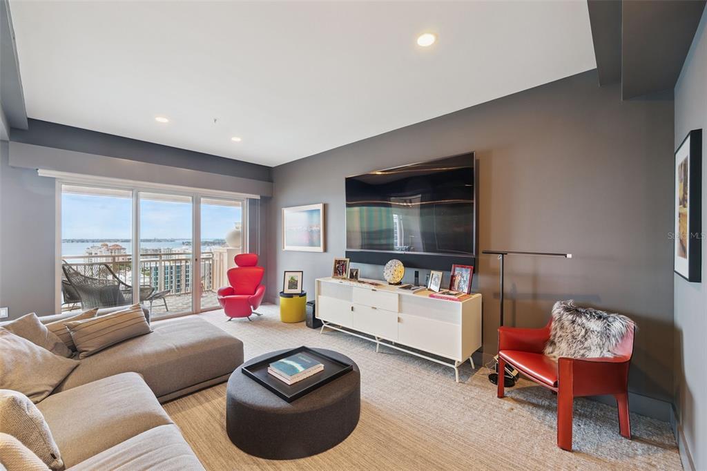1111 Ritz Carlton Drive, Unit 1704 Sarasota, FL 34236 - Photo 30 of 53 a living room with furniture and a flat screen tv