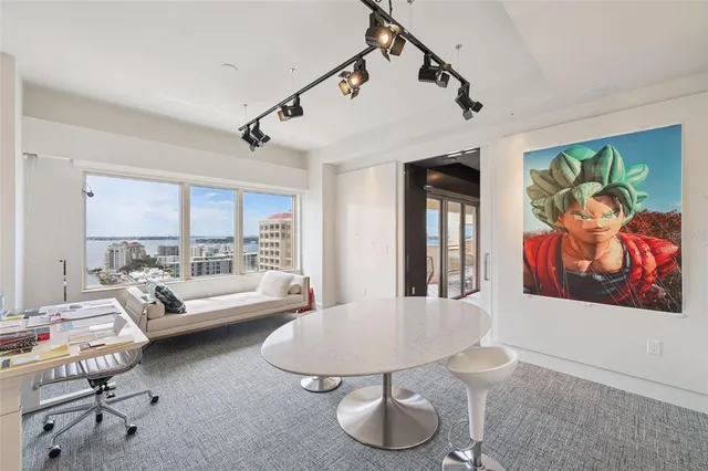 a spacious bedroom with a bed a couch and dresser in it