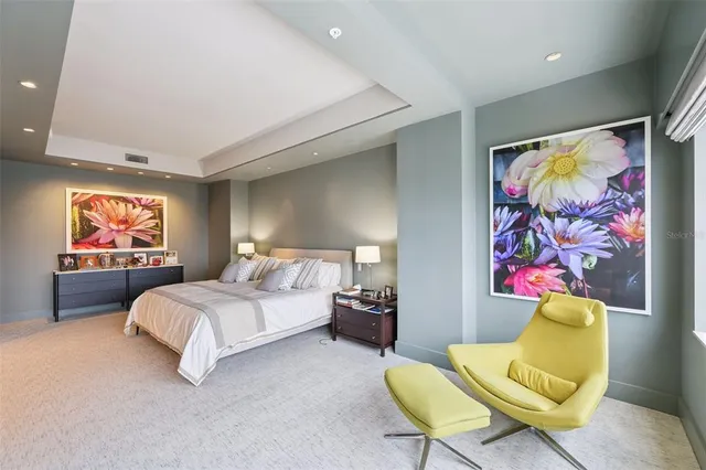 a spacious bedroom with a large bed and a large window