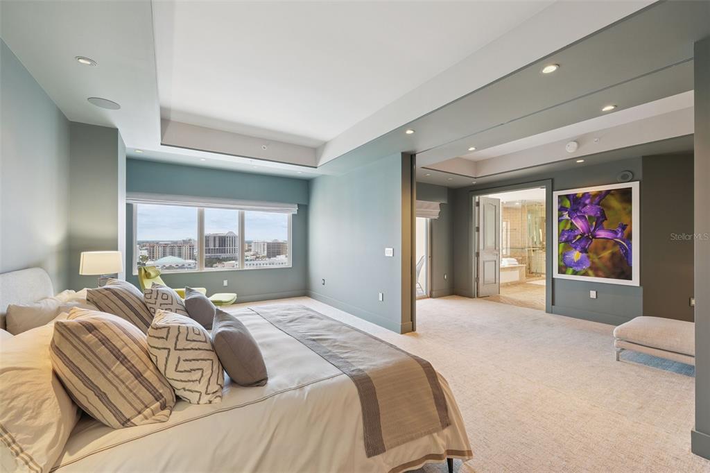 1111 Ritz Carlton Drive, Unit 1704 Sarasota, FL 34236 - Photo 37 of 53 a bedroom with a bed and glass wall